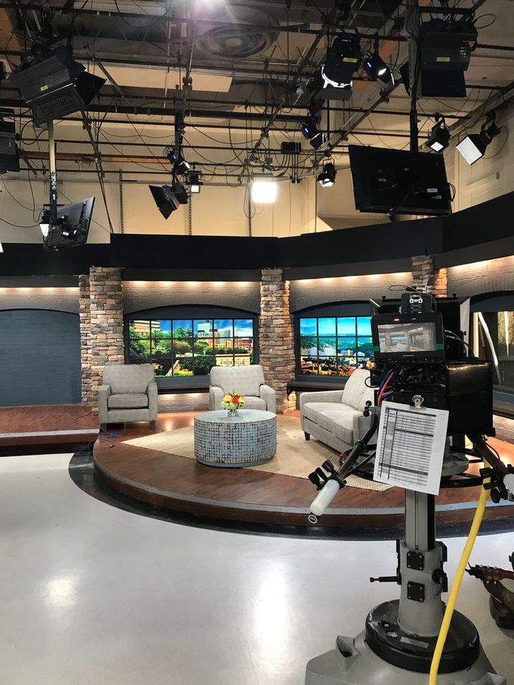 an empty television studio with chairs and lights