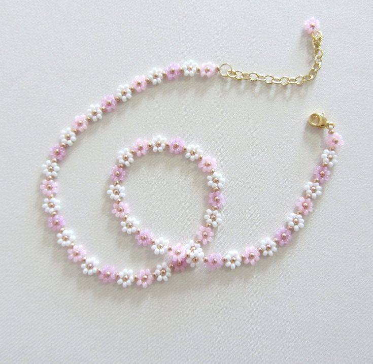 two bracelets with pink and white beads