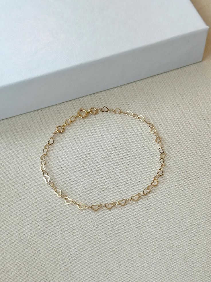 Hearts are melting for this dainty yet durable mini heart chain bracelet! 💛 This unique chain is sensitive skin and water safe, and is made to live your life in! Wear this minimal piece to brunch, or on a date... this simple heart chain looks lovely anywhere you take it! Details: * 3.5mm 14K Gold Filled heart chain * Dainty 14K Gold Filled spring clasp * 14/20 gf stamp for authenticity * Choose your length (each bracelet comes with a .5" extender chain for adjustable sizing.) * Made with all hypoallergenic and water safe materials 🤍 ✨ Pairs well with the Mini Heart Chain Necklace https://etsy.me/40aqcLB BRACELET MEASURING GUIDE: Average Women's Sizing: 5-6 inches = xtra small 6.5-7 inches = small 7-8 inches = medium 8 inches+ = large Please make sure to measure to get the right fit! Each Dainty Delicate Chain Bracelets For Valentine's Day, Dainty Delicate Chain Bracelet For Valentine's Day, Dainty Adjustable Open Heart Bracelet, Delicate Heart Bracelet With Delicate Chain, Delicate Heart-shaped Bracelets With Adjustable Chain, Adjustable Heart Bracelet With Delicate Chain For Valentine's Day, Adjustable Dainty Gold Bracelet With Heart Charm, Dainty Heart Bracelet With Delicate Chain For Valentine's Day, Dainty Chain Bracelet For Valentine's Day