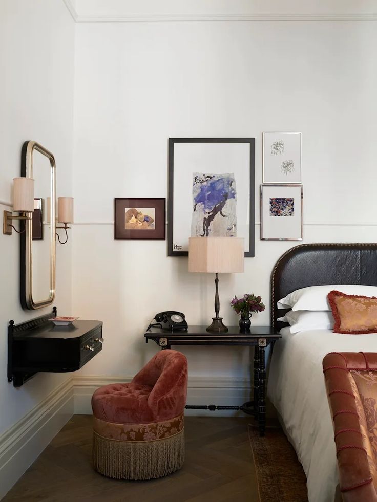 a bed room with a neatly made bed and pictures on the wall