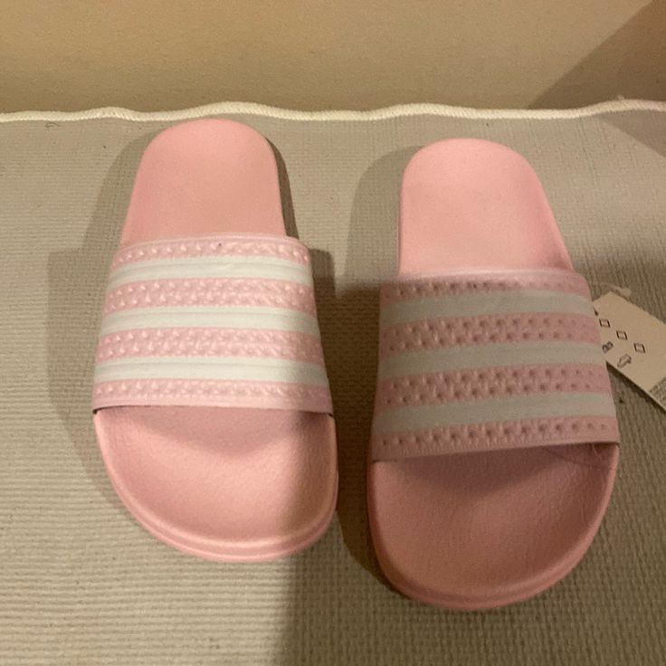 Brand New Women Adidas Light Pink And White Three Striped Adilette Slides Adidas Slides With Cushioned Footbed For Spring, Adidas Non-slip Summer Slides, Adidas Casual Slides For Spring, Adidas Synthetic Slide Sandals, Summer Adidas Slides, Adidas Casual Slide Sandals, Casual Adidas Slide Sandals, Adidas Casual Open Toe Slides, Casual Adidas Open Toe Slides