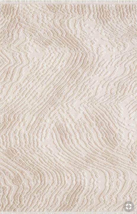 a white rug with wavy lines on it