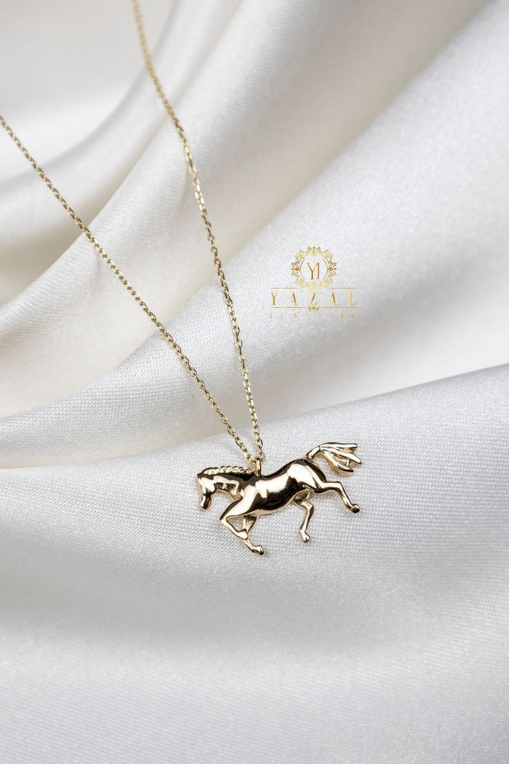 "ABOUT PRODUCT This 14K Gold Horse necklace is beautifully designed and hand crafted with our associates to make this a special gift for your loved ones. Knowing the value of our customers, We prepare each piece with extra care and attention. ITEM DETAILS Material: 14K Gold Approx: 3,2 gr  Only Pendant 2,4 gr Available colors: Gold, Rose Gold, White Gold Available Sizes: 14\" to 20\" ✪ 14k Solid Gold ( Certification will be included with your order ) ✪Available 14K White, Yellow, Rose Gold (also Elegant Gold Jewelry With Horse Design, Elegant Horse Design Pendant Jewelry, 14k Gold Filled Charm Necklace As A Gift, 14k Gold Filled Charm Necklaces For Gifts, 14k Gold Filled Charm Necklace For Gifts, Elegant Yellow Gold Jewelry With Horse Design, Elegant Necklace With Horse Design As A Gift, Elegant Horse Design Necklace As Gift, Elegant Round Jewelry With Horse Design