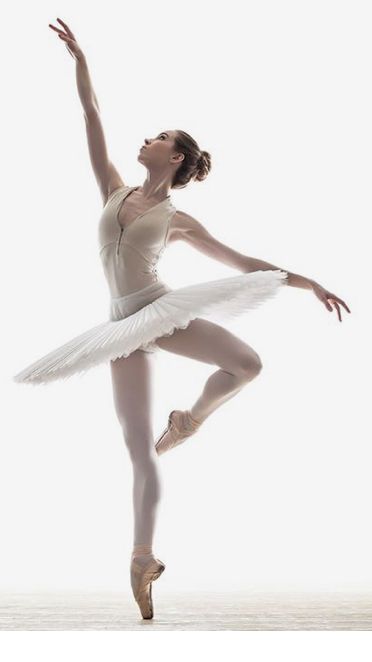 a ballerina in white is posing for the camera