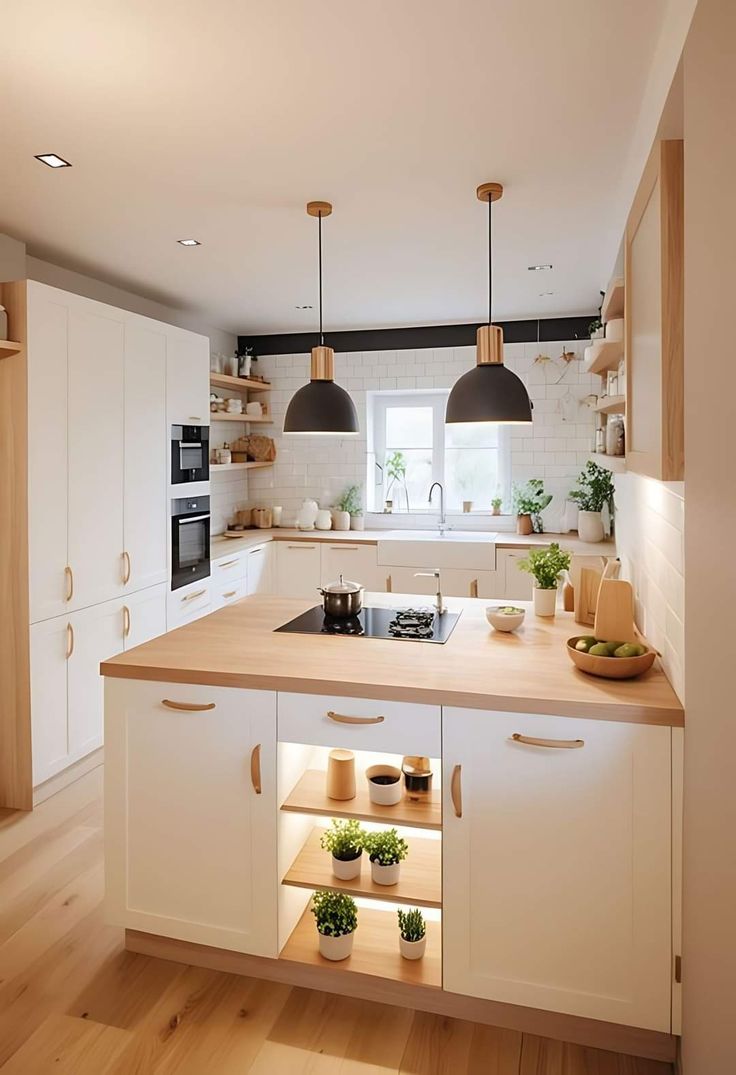 a kitchen with wooden floors and white cabinets, lights above the stove top and sink