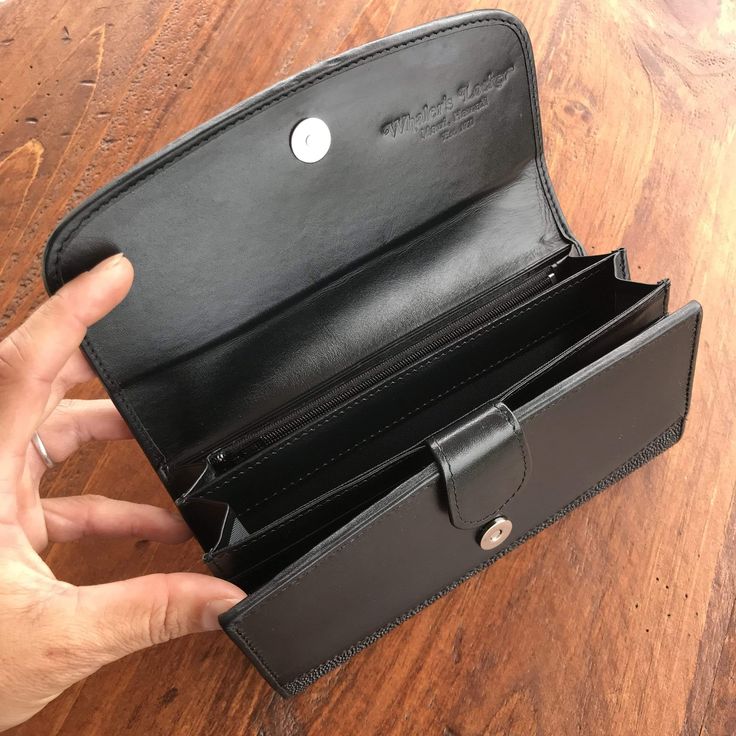 Trade your traditional wallet in and upgrade to something attractive and unique with our Stingray Leather Clutch Wallet. This clutch brings together the functionality of a conventional wallet with the elegance of a black-tie affair accessory. The exterior of this wallet is made exclusively with genuine stingray leather. The interior is made with vow leather and features a zippered coin pocket, divided bill carrier, plastic identification sleeve, and nearly a dozen card slots. The stingray leathe Elegant Wallets With Removable Pouch As Gift, Black Leather Clutch With Coin Pocket, Classic Black Clutch With Card Slots, Compact Rfid Blocking Wallets For Formal Occasions, Compact Rfid-blocking Wallet For Formal Occasions, Black Bifold Wallet On Chain With Card Slots, Compact Leather Wallets For Formal Occasions, Compact Leather Wallet For Formal Occasions, Elegant Clutch With Interior Card Slots