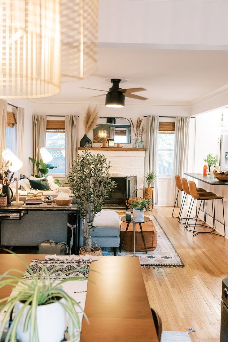 a living room filled with furniture and a fire place in the middle of a kitchen