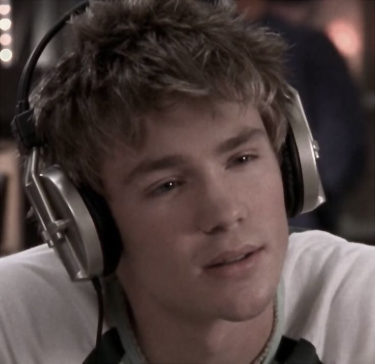 a young man wearing headphones and listening to music