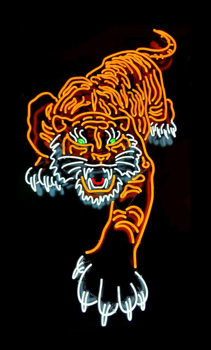 a neon tiger sign is lit up in the dark