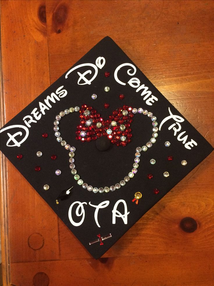 a graduation cap decorated with beads and a mickey mouse head on it that says dreams come true