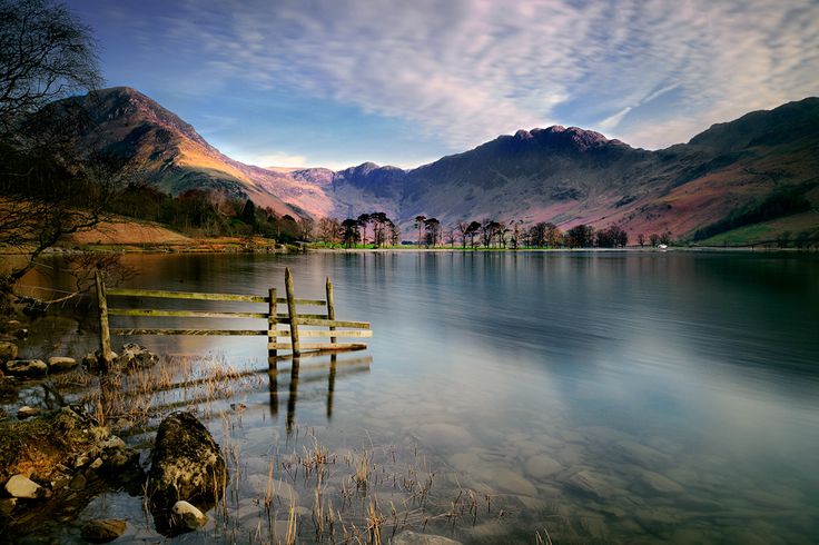 a lake with mountains in the background