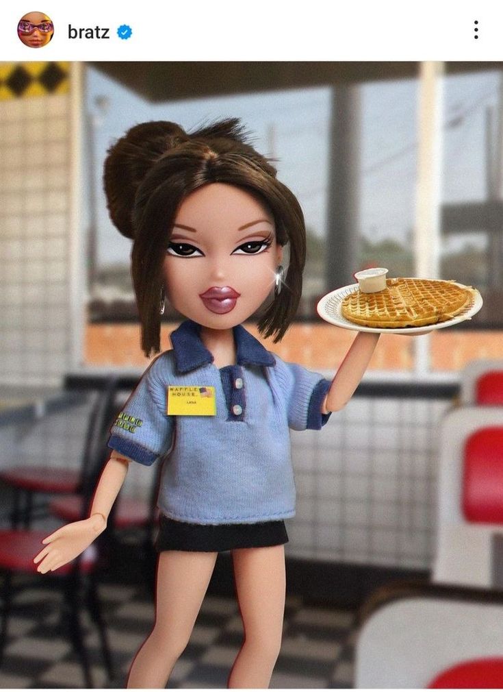 the doll is holding a plate of waffles