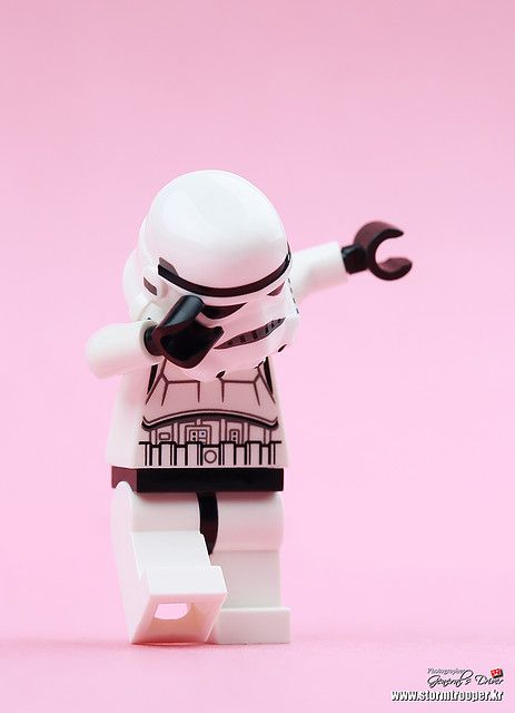 a lego star wars character holding a wrench in one hand and pointing at something on the other