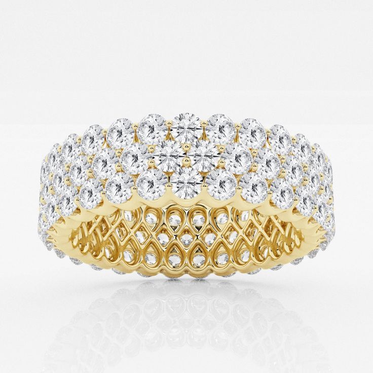 two tone gold and white diamond wedding ring with an intricate design on the center band