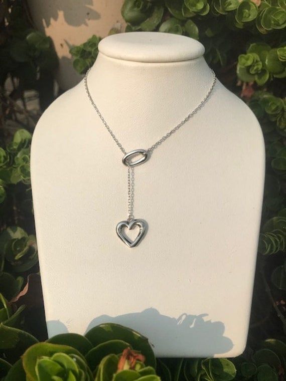 Beautiful lariat has a heart on the end.  The sterling silver chain is 21 inches if measured all the way around.  Stunning, classy gift of love! Elegant Lariat Heart Necklace Gift, Elegant Lariat Heart Charm Necklace, Elegant Heart Lariat Necklace With Adjustable Chain, Elegant Heart Shaped Lariat Necklace With Clavicle Chain, Elegant Lariat Heart Necklace With Adjustable Chain, Elegant Heart-shaped Lariat Necklace With Clavicle Chain, Elegant Adjustable Lariat Necklace With Heart Pendant, Elegant Adjustable Heart Pendant Lariat Necklace, Adjustable Heart Pendant Lariat Necklace For Valentine's Day