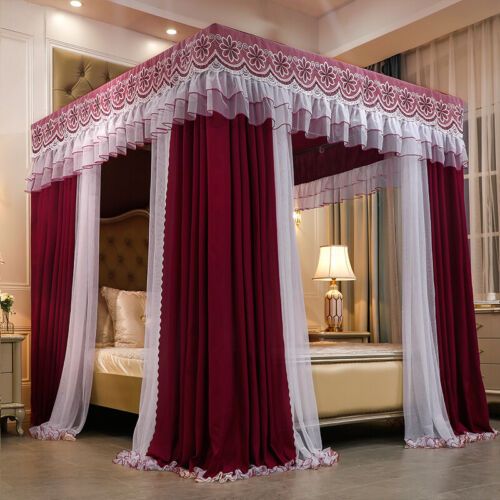 a canopy bed with red and white drapes