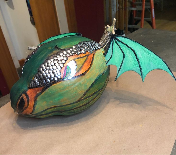 a green dragon sculpture sitting on top of a table