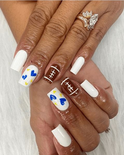 2024’s Trendiest Football Nail Designs – Show Your Team Spirit in Style Football Mom Nails Design, Team Color Nails, La Rams Nails, Chicago Bulls Nails, Blue And Gold Football Nails, Fall Football Nail Designs, Team Spirit Nails, School Spirit Nails Designs, Blue And Yellow Nail Ideas