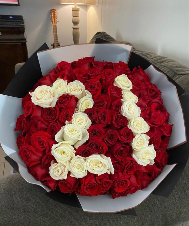 a large bouquet of red and white roses in the shape of the number twenty eight