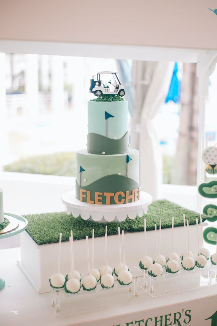 a golf themed wedding cake is displayed on a table