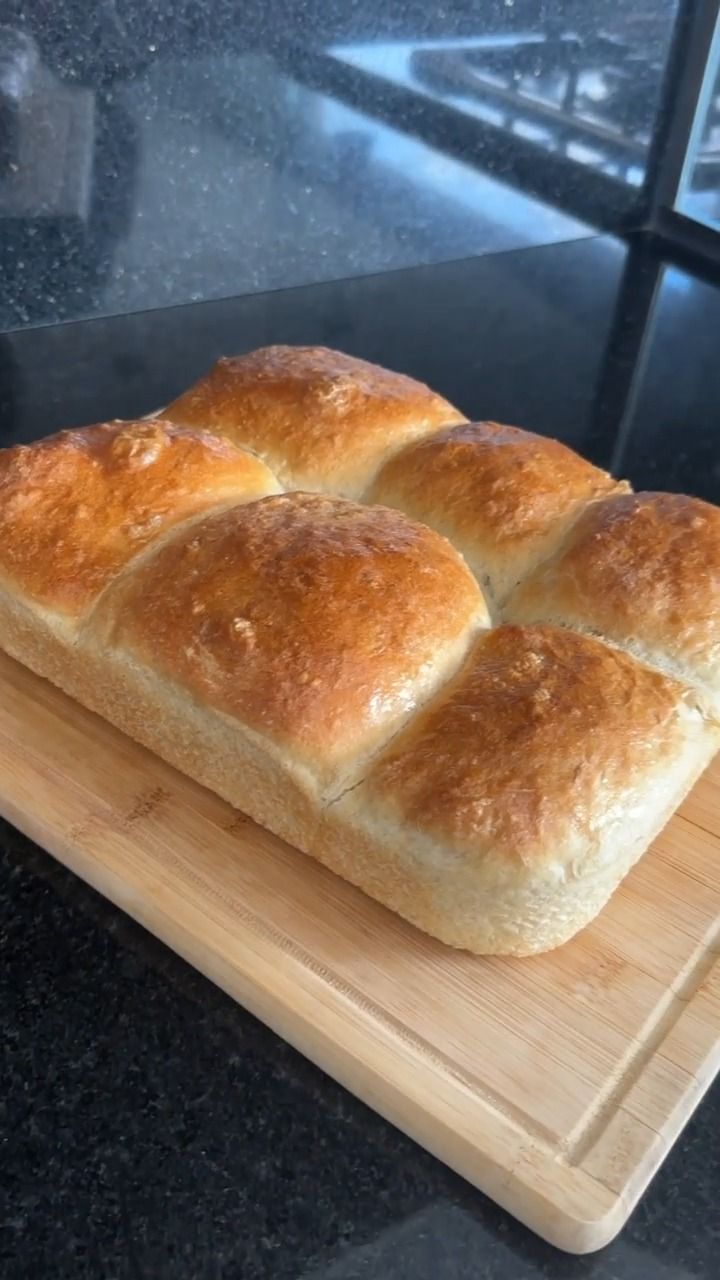 a loaf of bread sitting on top of a wooden cutting board