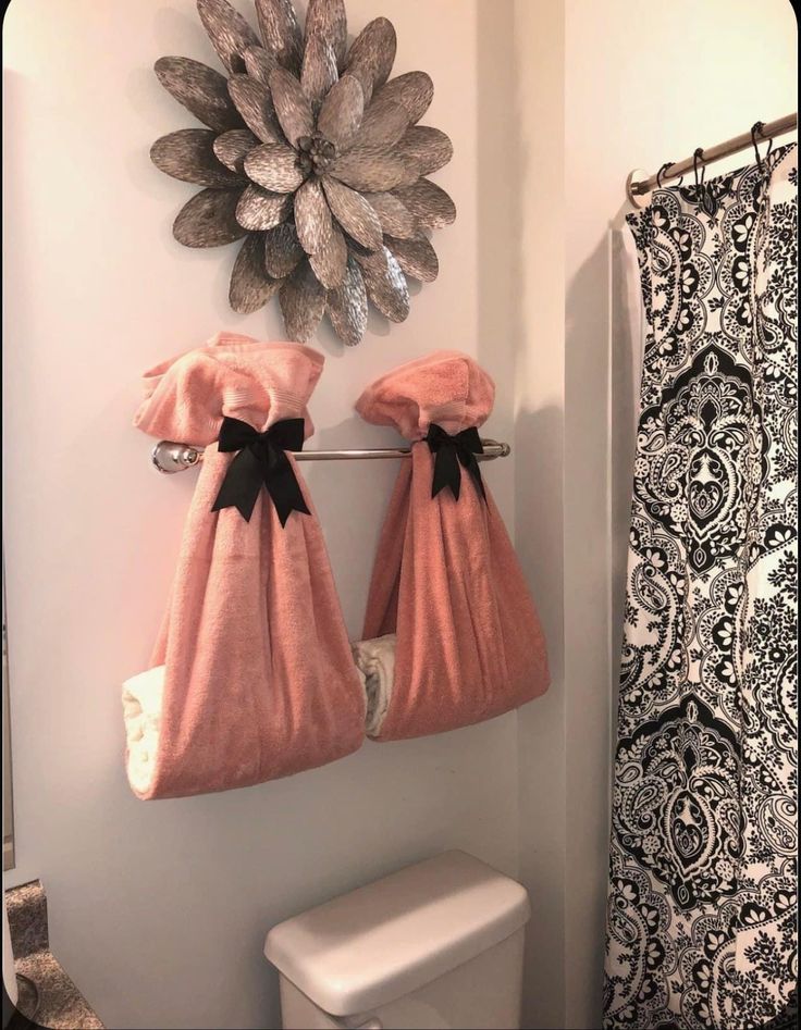 two towels are hanging on the towel rack in front of a toilet and shower curtain