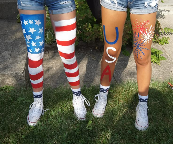 two girls wearing patriotic leggings with stars and stripes painted on them, standing next to each other