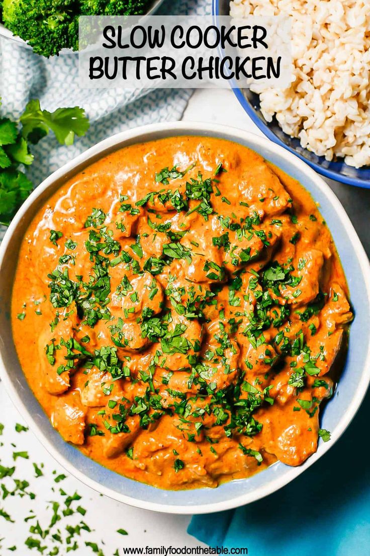 slow cooker butter chicken in a bowl with rice and broccoli on the side