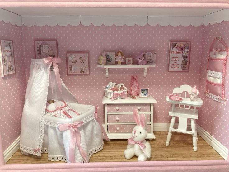 a doll's room with pink and white accessories