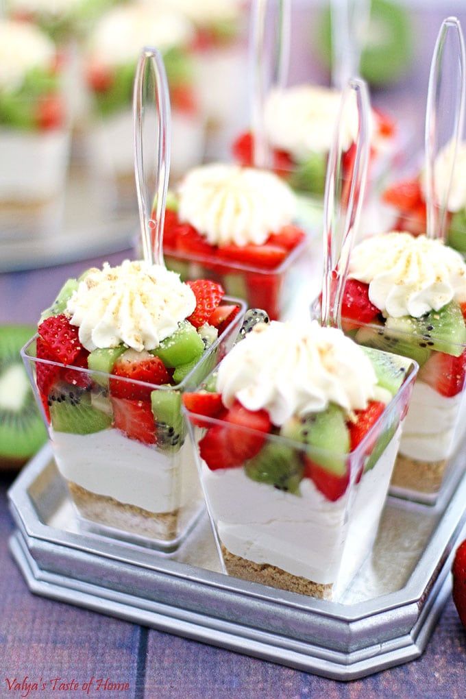 desserts are arranged in small plastic containers on a tray