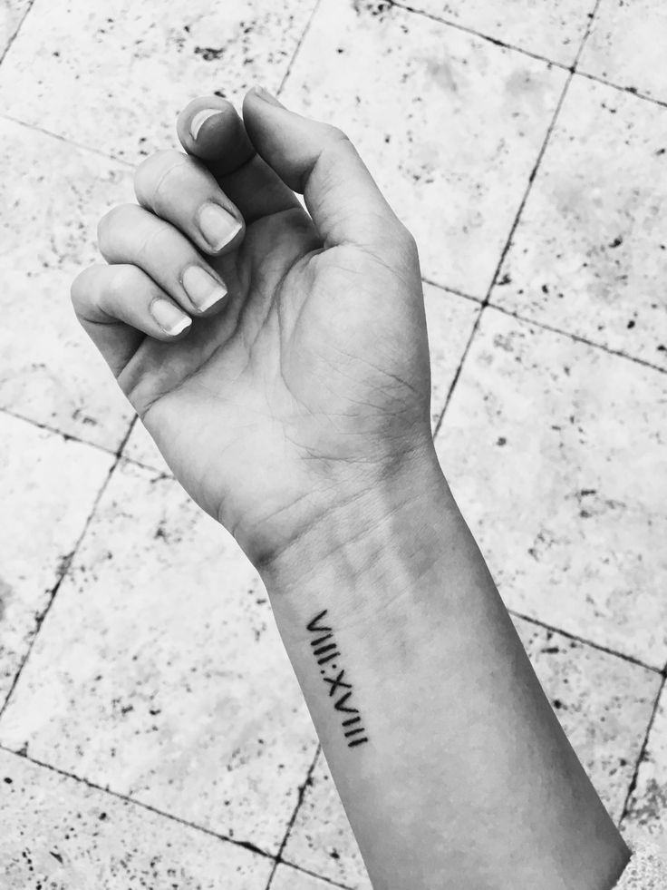 a black and white photo of a person's arm with the word ink on it