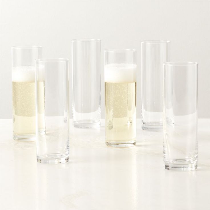 several glasses are lined up next to each other