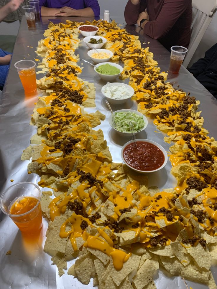 a long table filled with chips and dips