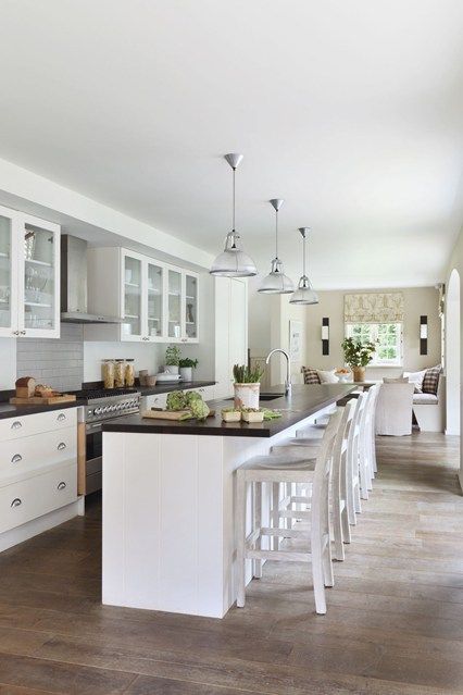 an image of a kitchen setting with white cabinets and counter tops on the phone screen