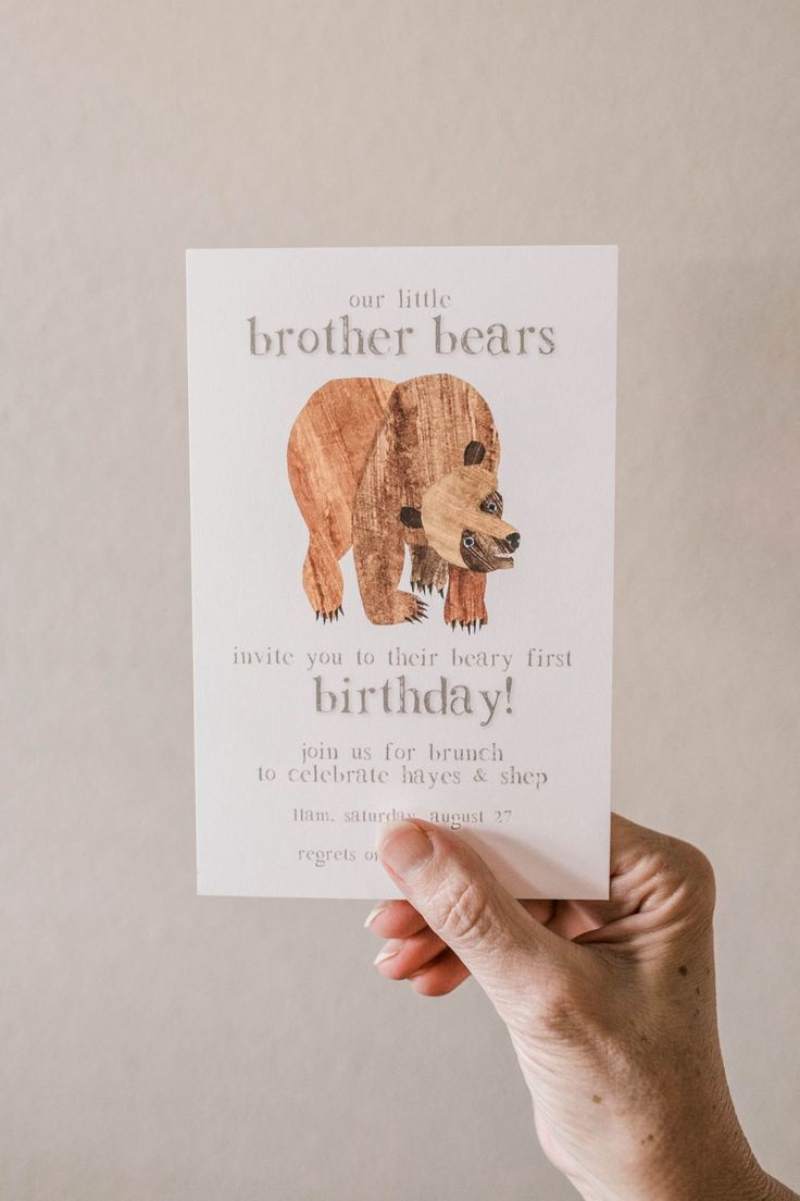 someone holding up a card that says, our little brother bears have you to be happy first birthday?