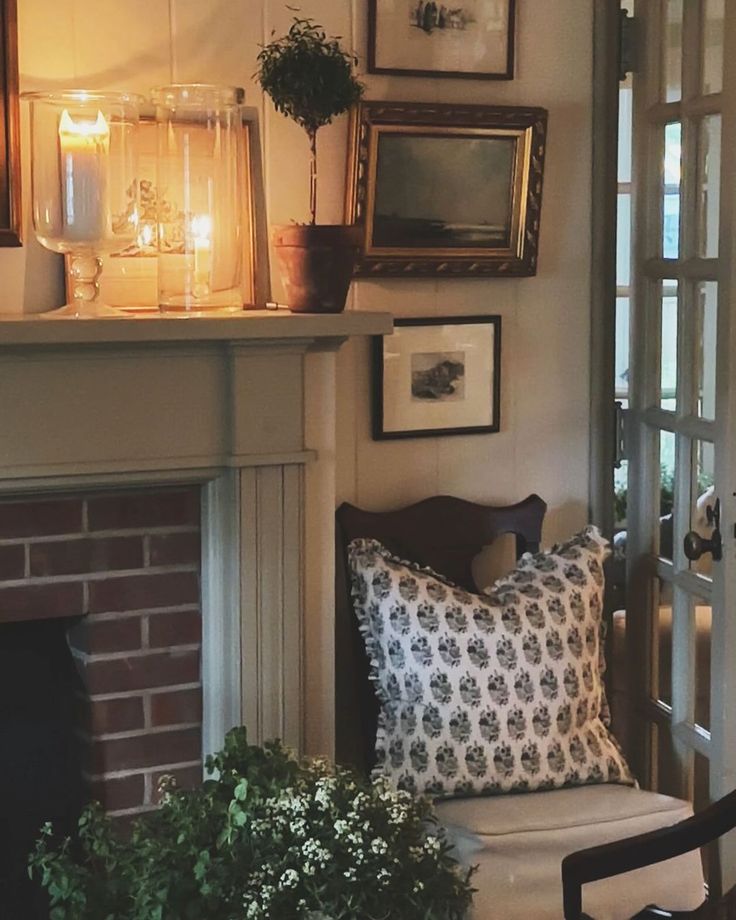 a living room filled with furniture and a fire place next to a fireplace covered in pictures