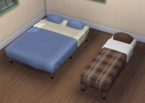 a room with two beds, a couch and a chair in the corner next to each other