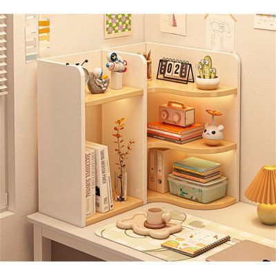 an open book shelf in the corner of a room with books and other items on it