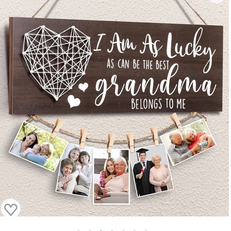 a wooden sign with photos hanging from it's clothes line and the words i am as lucky as can be the best grandma belongs to me