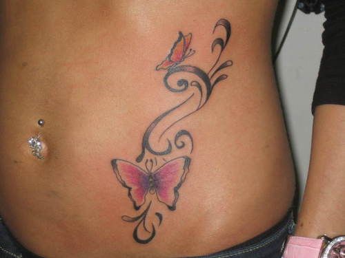 a woman's stomach with a butterfly tattoo on her belly and the bottom part of her stomach