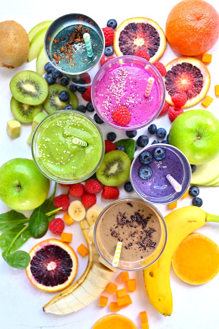 there are many different fruits and smoothies on the table