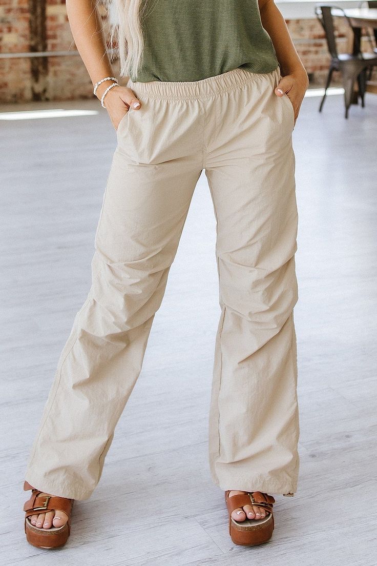 Suit up in style with Petra Parachute Pants! These pants provide a comfortable fit with their soft and lightweight parachute material that moves with your every step. Enjoy maximum freedom of movement while turning heads with their modern design! Get ready to look amazing wherever you go! Model Info: Models are 5'7", Size 2, wearing smalls Fabric: 100% nylon Stretch Parachute Trousers In Solid Color, Stretch Solid Color Parachute Trousers, Casual Relaxed Fit Cargo Yoga Pants, Stretch Nylon Wide-leg Parachute Pants, Stretch Nylon Parachute Pants For Summer, Versatile Nylon Summer Bottoms, Spring Wide-leg Pants For Outdoor Activities, Spring Wide Leg Pants For Outdoor Activities, Wide-leg Pants For Spring Outdoor Activities