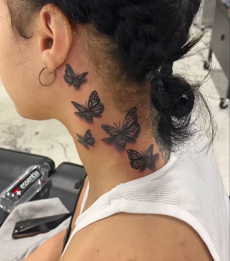 a woman with black butterflies on her neck