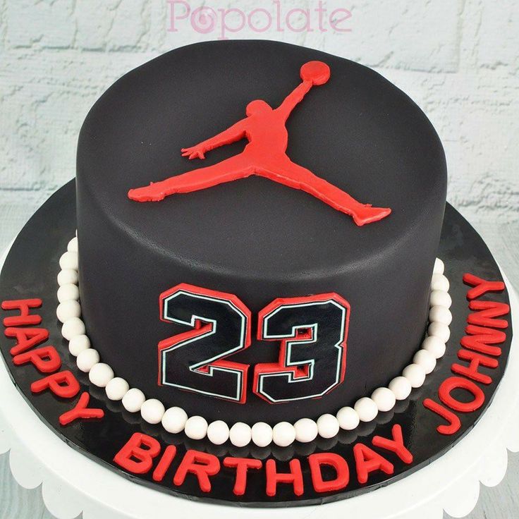 a black and red birthday cake with the number 23 on it