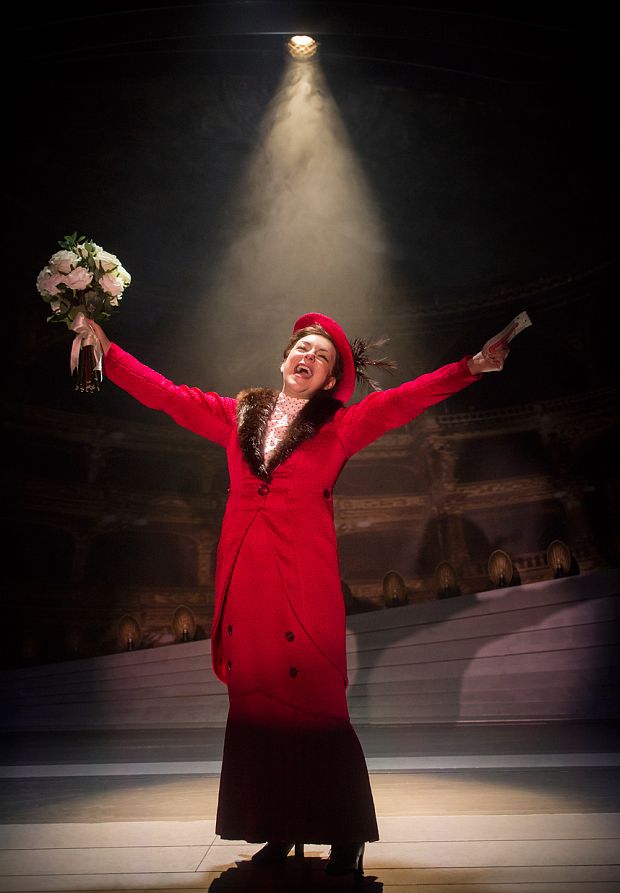 a woman in a red coat is holding flowers