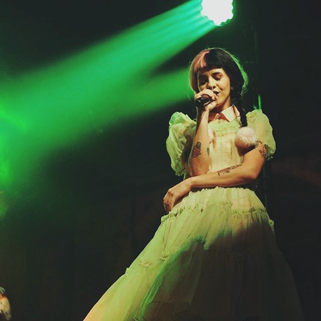 a woman in a green dress on stage