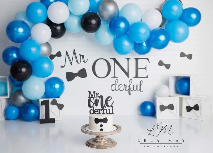 a blue and white birthday party with balloons