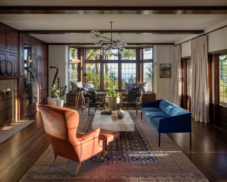 a living room filled with furniture and a fire place in front of a large window