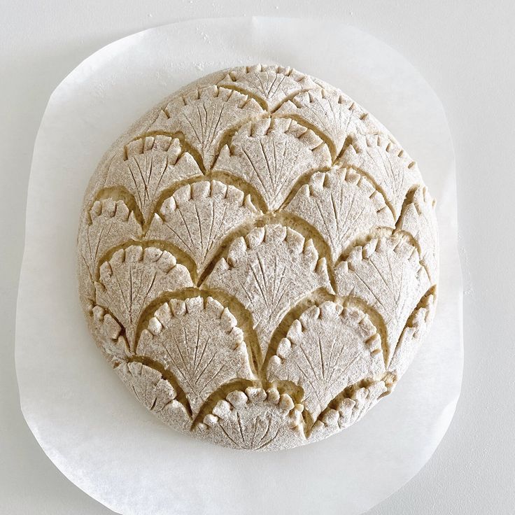 a white plate topped with a pastry covered in frosting on top of a table