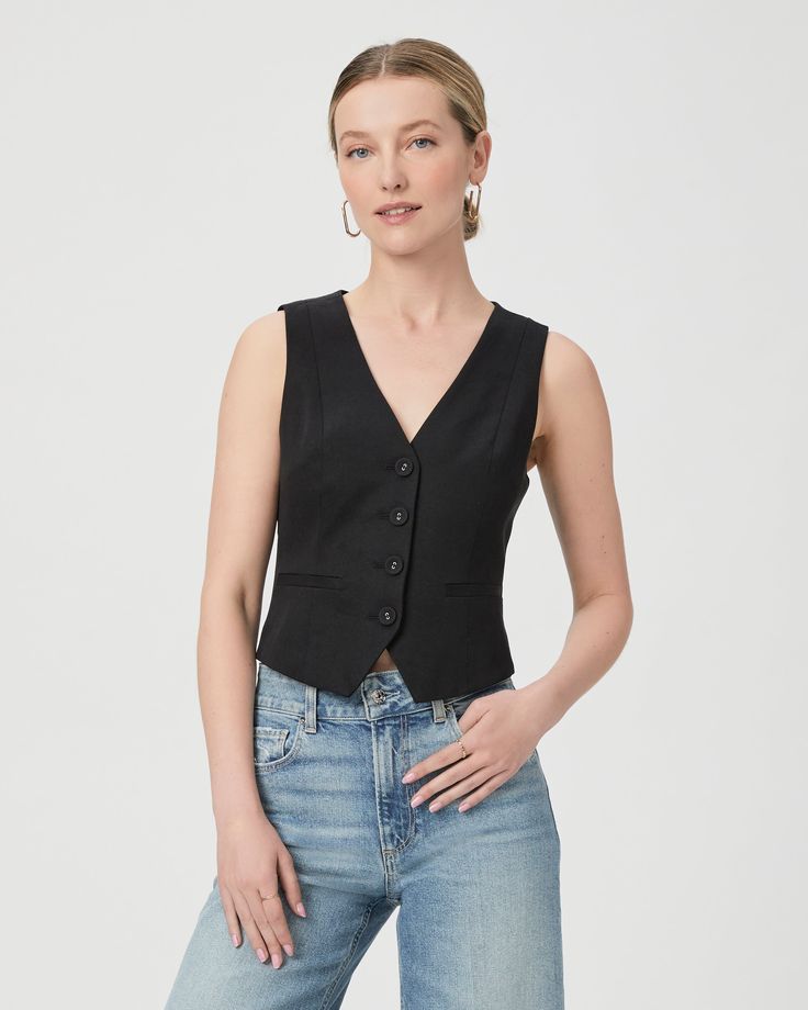 Made from a supremely soft cotton blend, this sleeveless black vest top is designed with front princess seams, covered buttons, welt pockets, and a front and back notch. Pair the Iris Vest with any shade of denim. | Iris Vest Top - Black | Size 12 Chic Sleeveless Denim Vest For Work, Chic Denim Vest For Workwear, Chic Denim Vest For Work, Classic Cotton Tank Top For Work, Fitted Sleeveless Top With Pockets, Elegant Cotton Sleeveless Blouse Vest, Sleeveless Tailored Tops With Pockets, Sleeveless Cotton Workwear Vest, Fitted Cotton Tank Top For Work